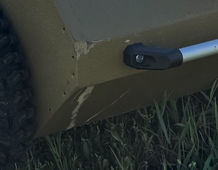 Close-up of minor local edge damage and coating abrasion on HARDY FLEX after the concrete-wall collision